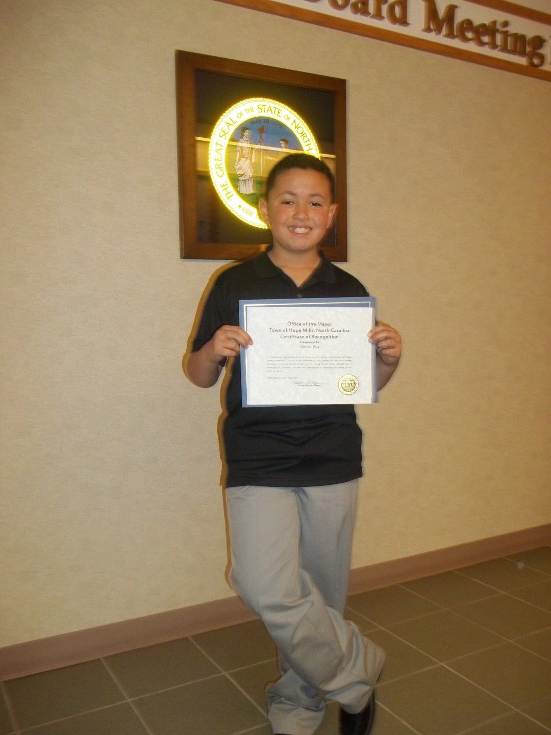 Alizdair Proudly Displays His Certificate