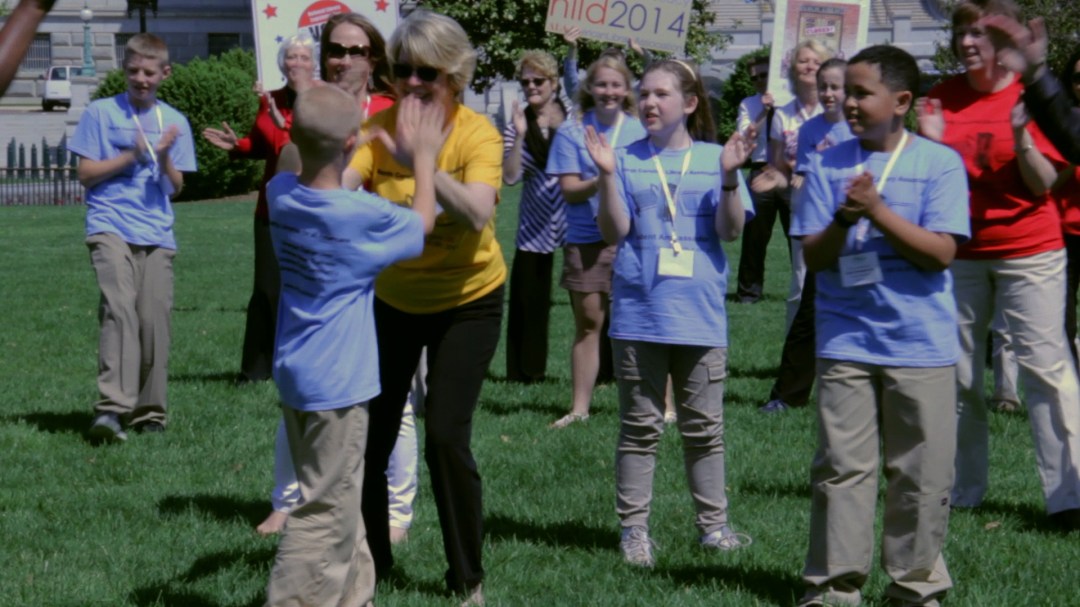 Garner, NC 4th grader Lincoln Sawyer giving a high-five to NC State Librarian Cal Shepard